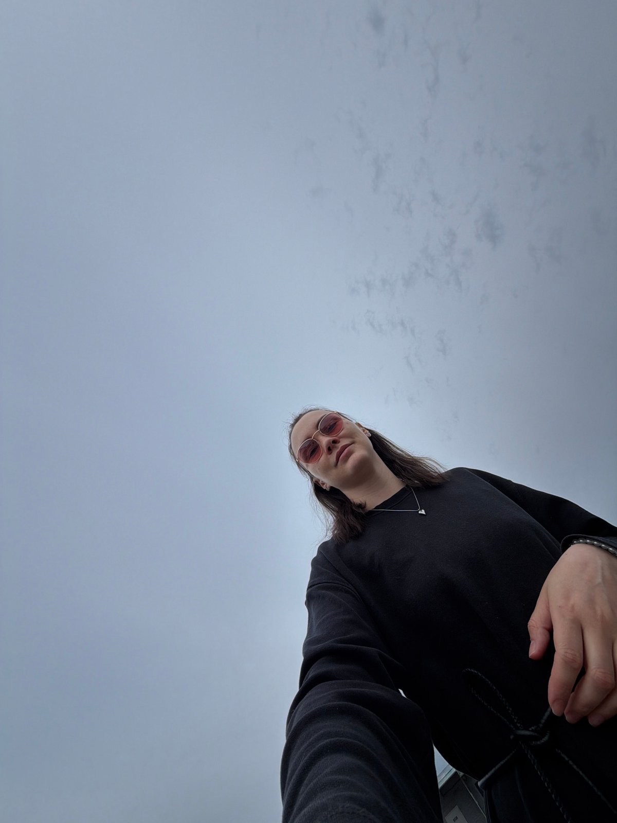 Person photographed in rose-tinted glasses in Chaikovsky, Russia