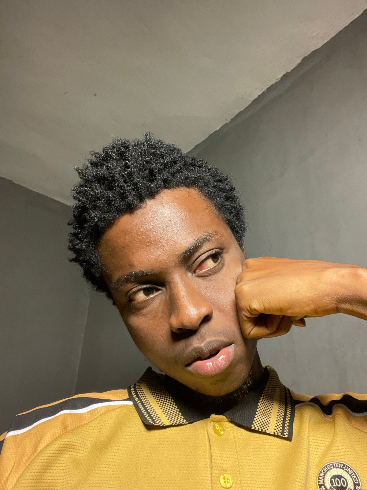 Indoor selfie session in Nkpor, Nigeria, yellow polo and shades