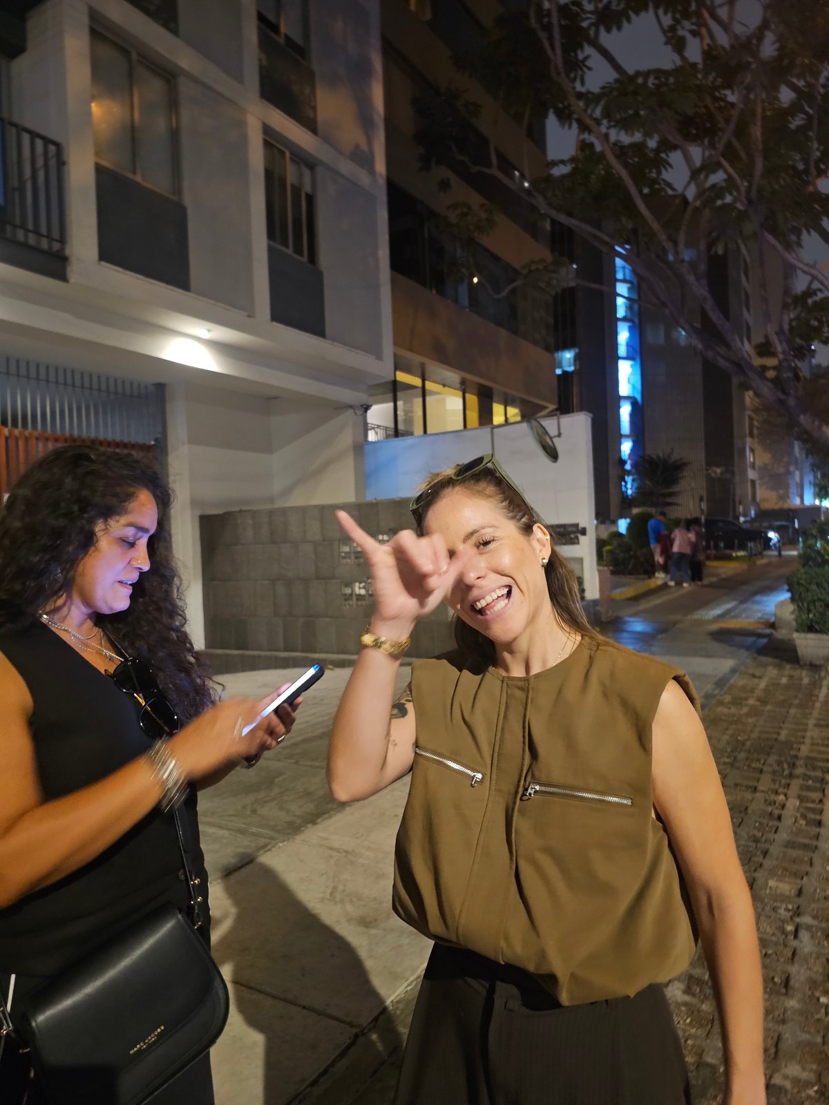 Two women spotted together in nighttime Miraflores, Peru