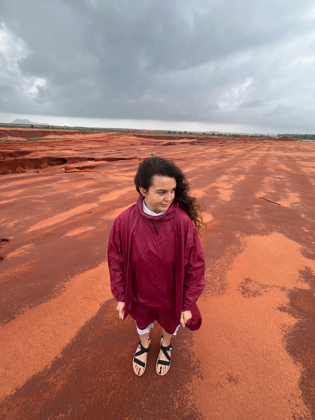 Posing across Mui Ne's red sand dunes on a cloudy day