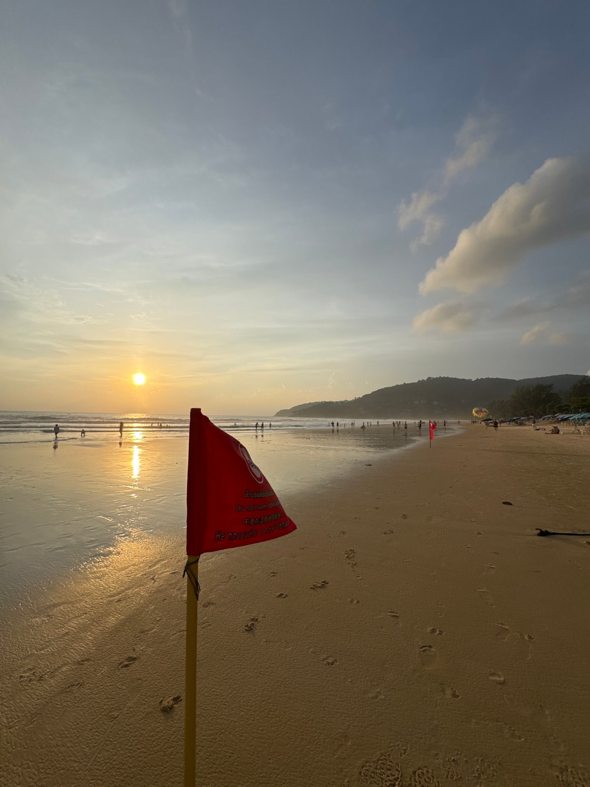 Karon Beach: red swim warning, parasailing, and golden hour