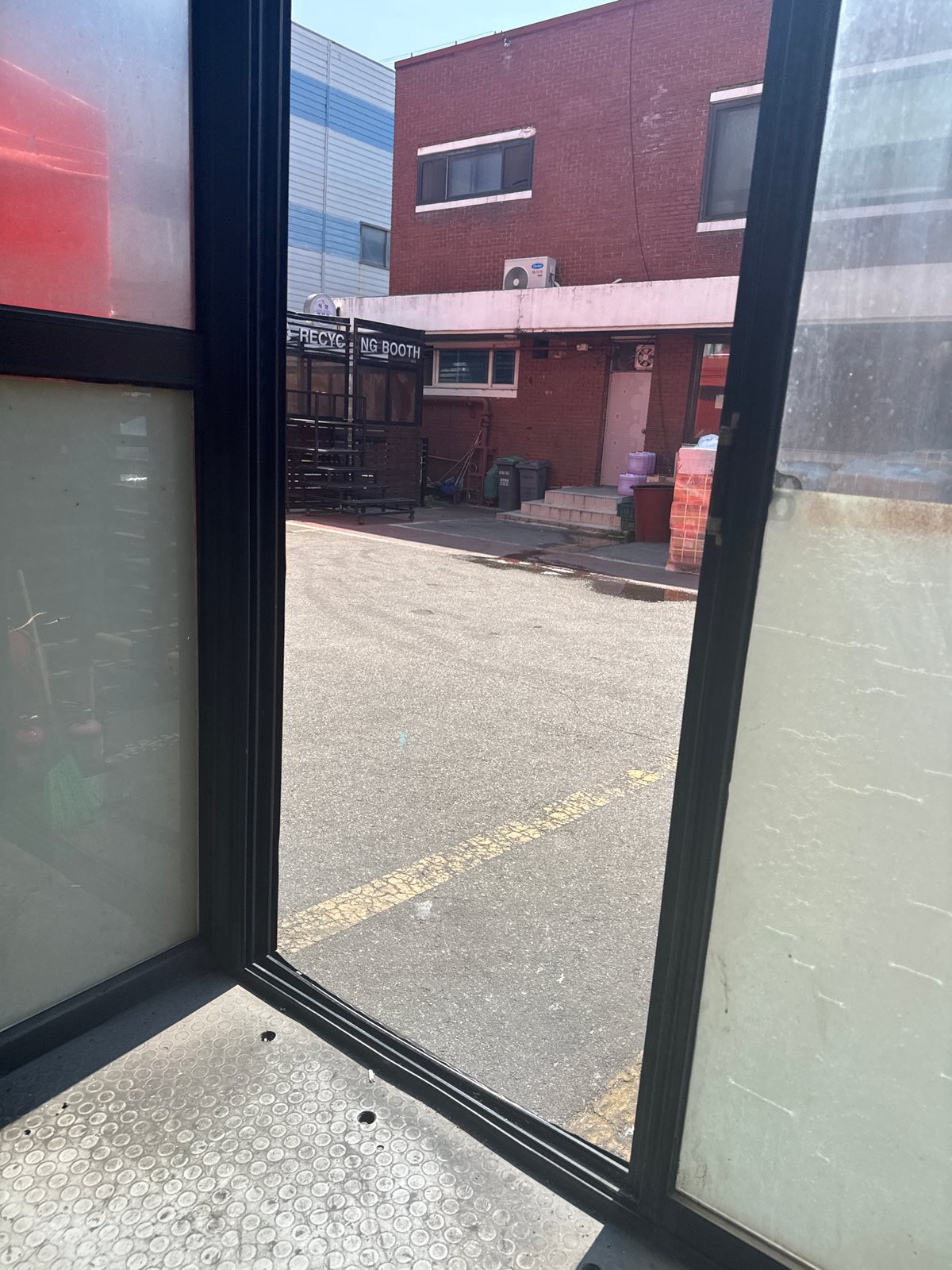 Inside and outside an Ansan industrial warehouse, mid-morning