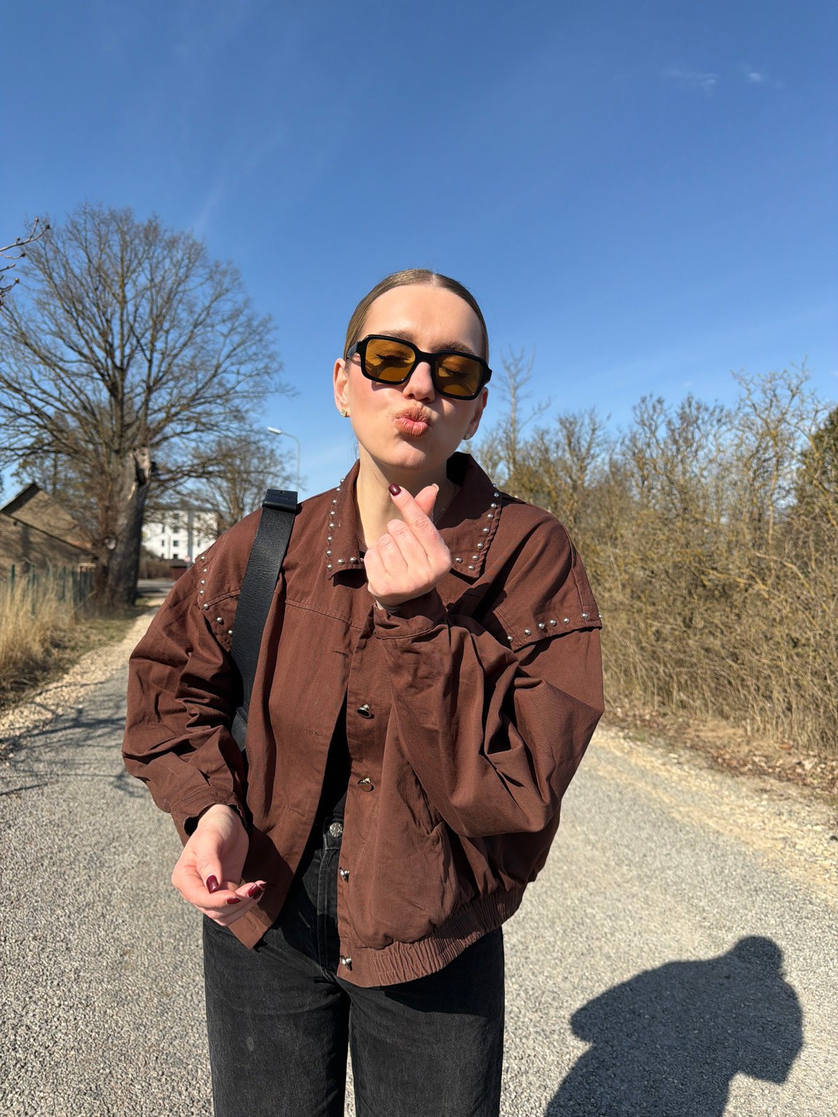 Woman poses for photos on Dreiliņi road