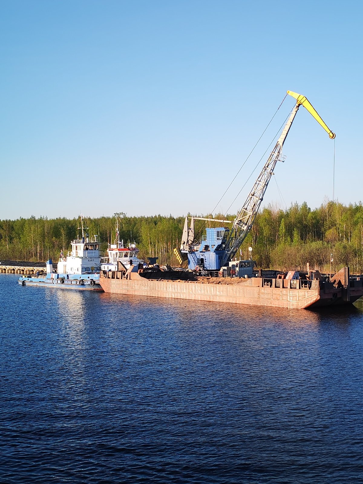 Maritime vessels active at Russian waterfront early morning