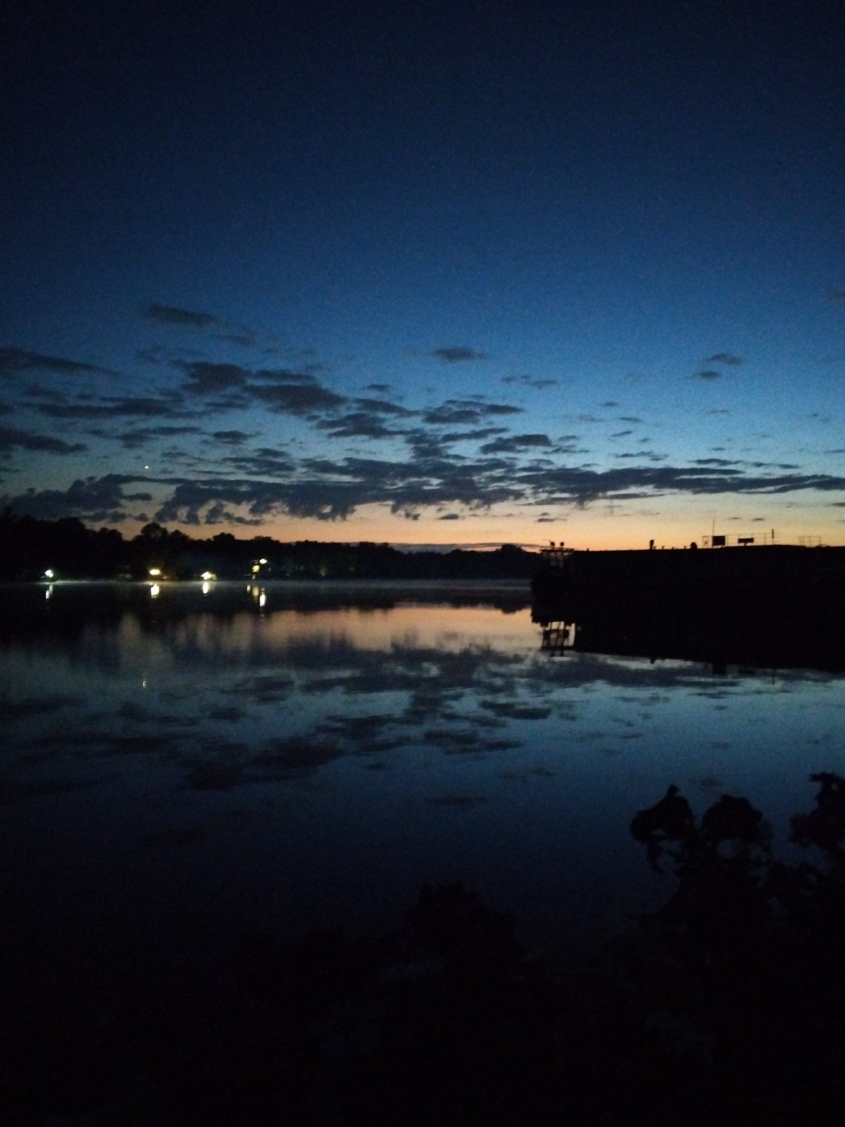 Twilight settling over a Kyiv waterfront, July 2026