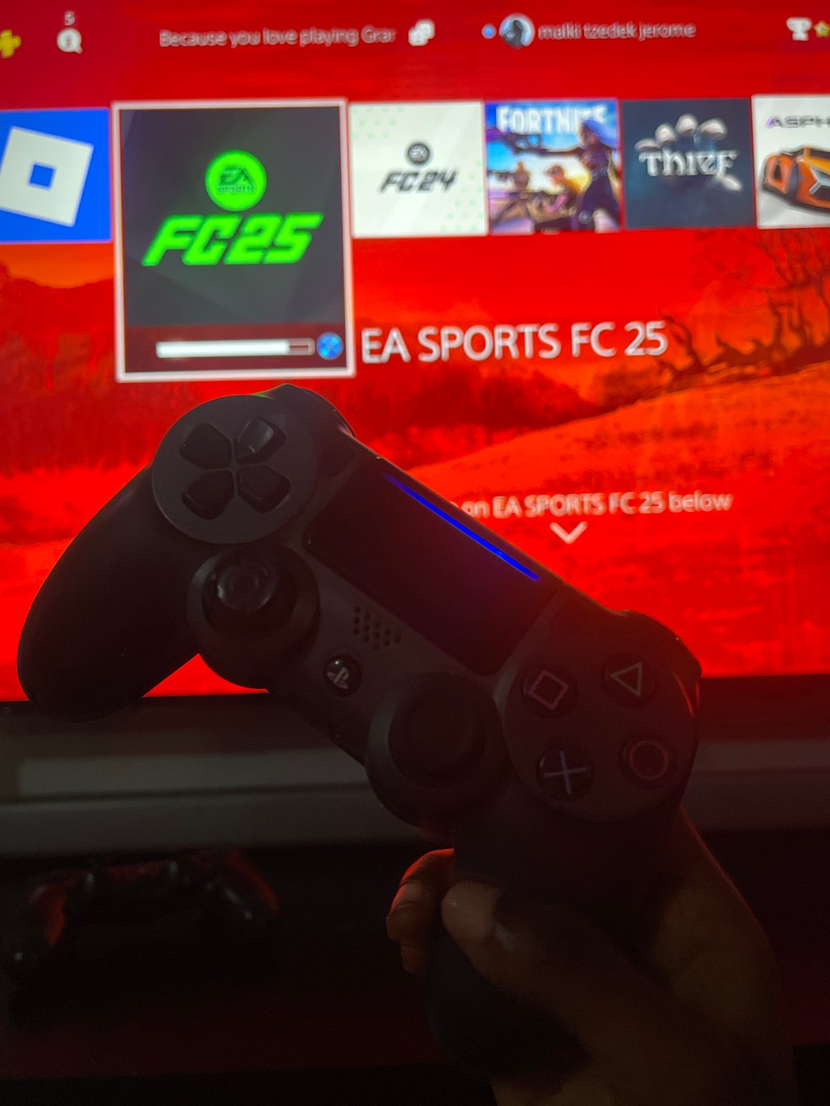 Child plays fighting game on PlayStation in Ado, Nigeria