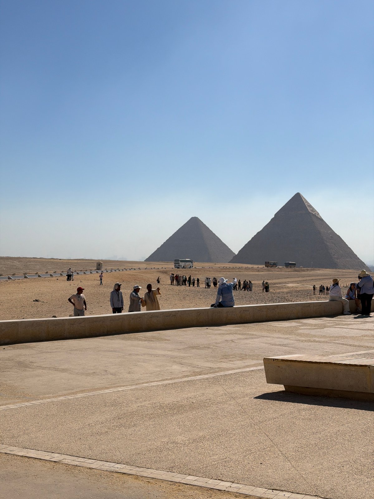 Tourists gather at the Giza Pyramids on a summer morning.