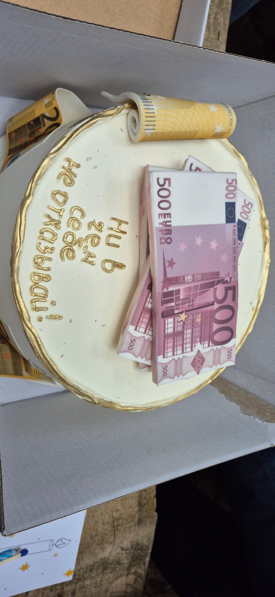 Birthday celebration with Euro-themed cake held outdoors in Montenegro