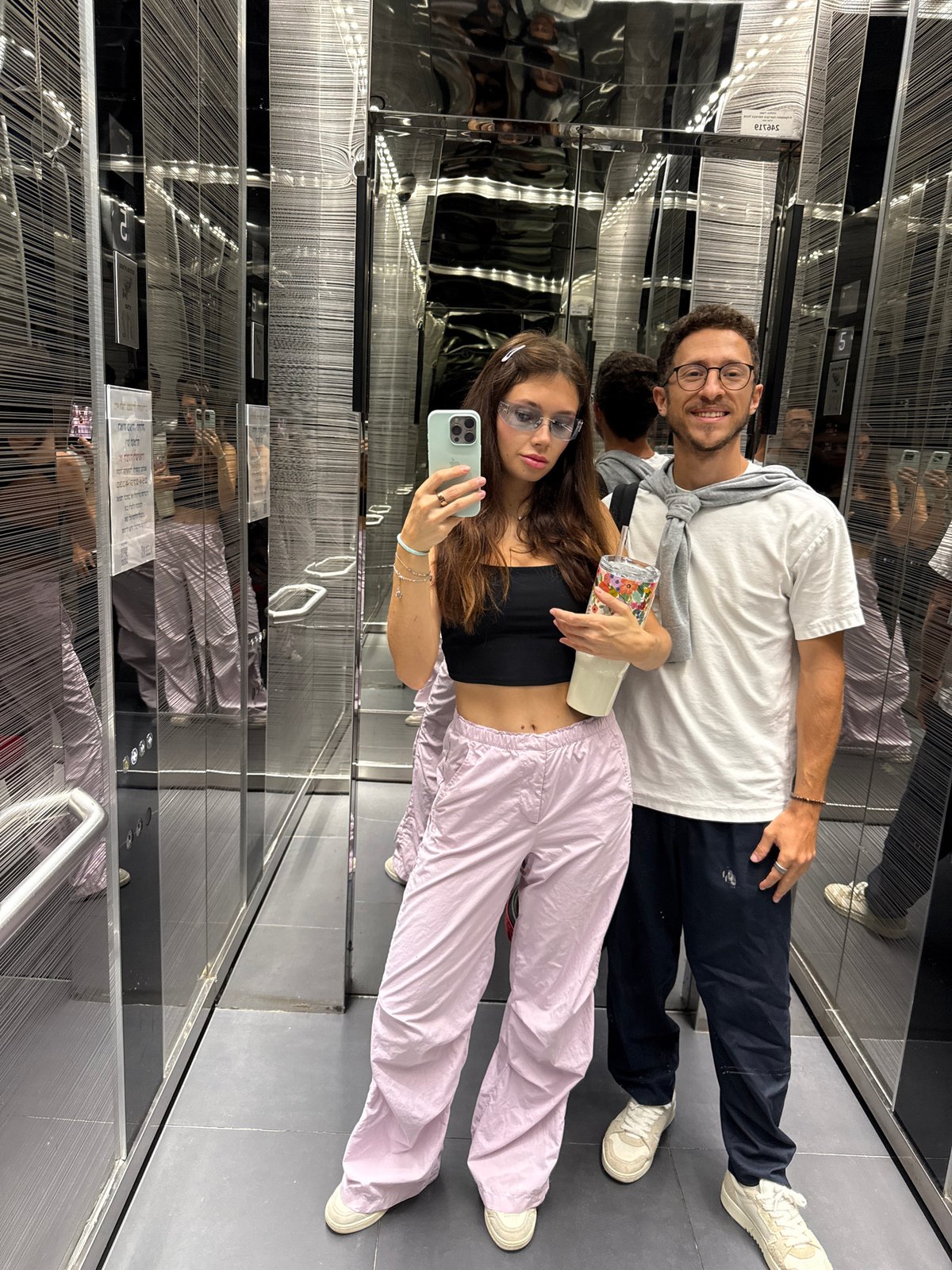 Couple takes selfie in mirrored elevator in Tel Aviv