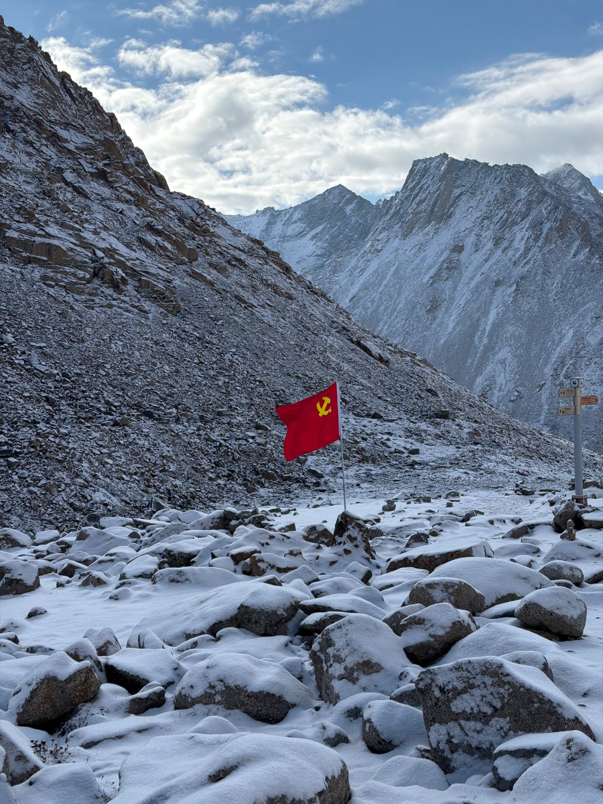 Communist flag planted on snowy Chinese mountain peak
