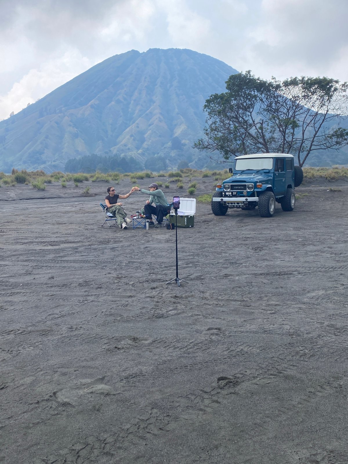 Two people filmed near Toyota on volcanic terrain, Indonesia