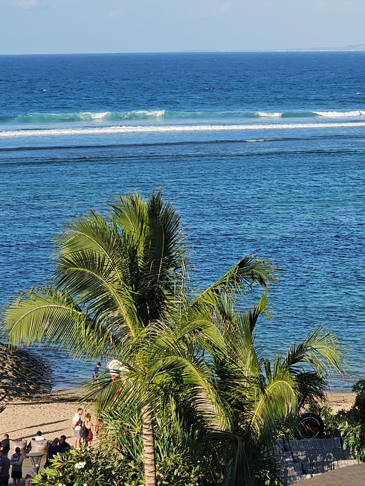 Bali coastline: palm views, rocky shores, and anchored yachts
