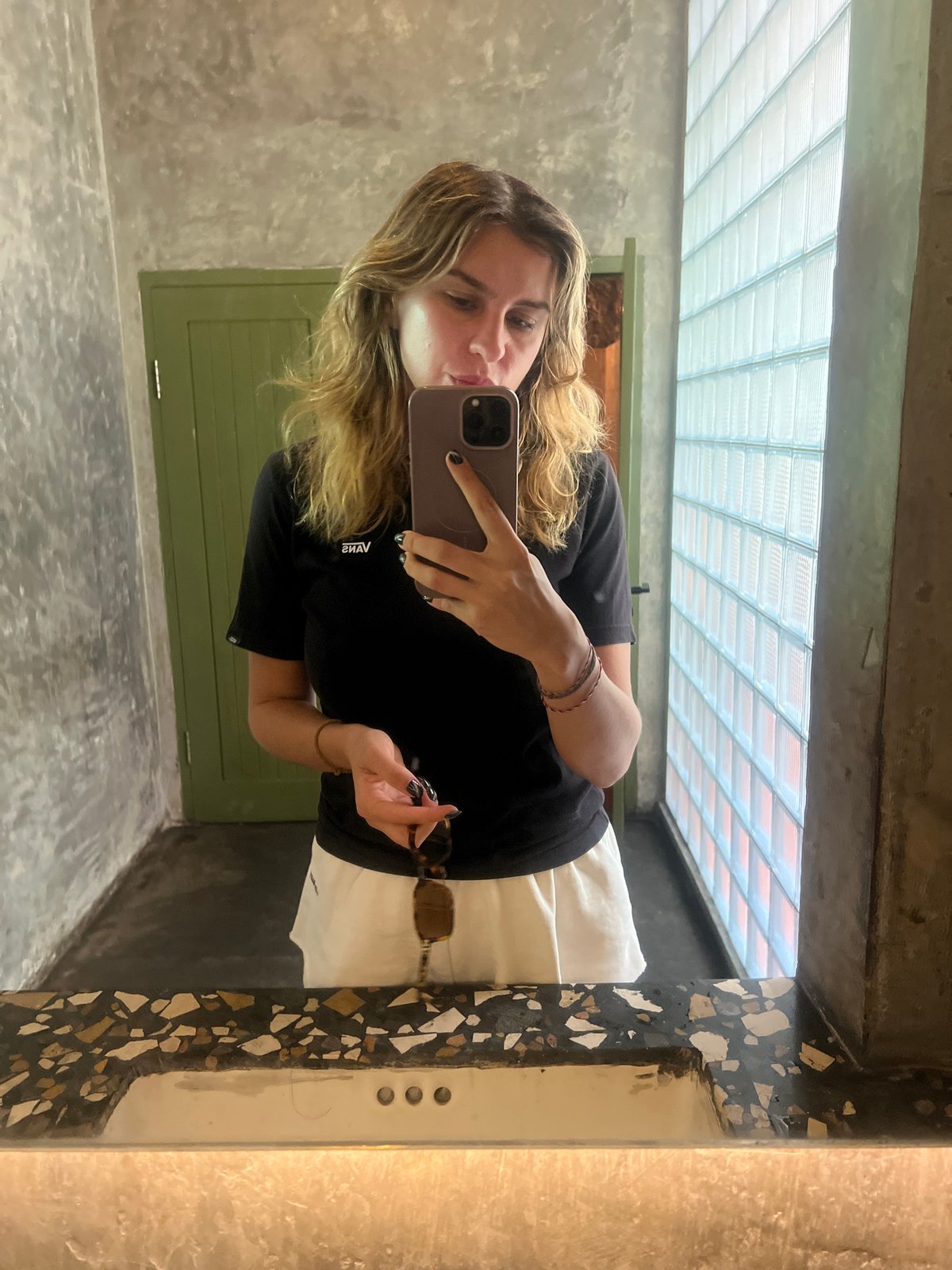 Casual mirror selfie in a concrete bathroom, Kuta Selatan.