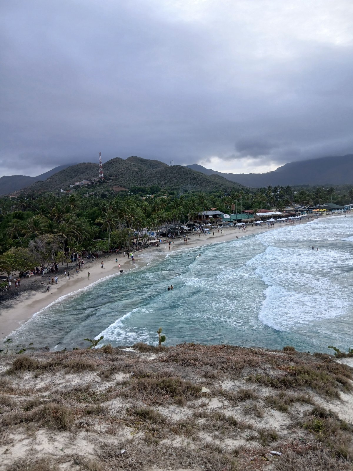 Witness captures overcast beach scene with cloud-obscured mountains