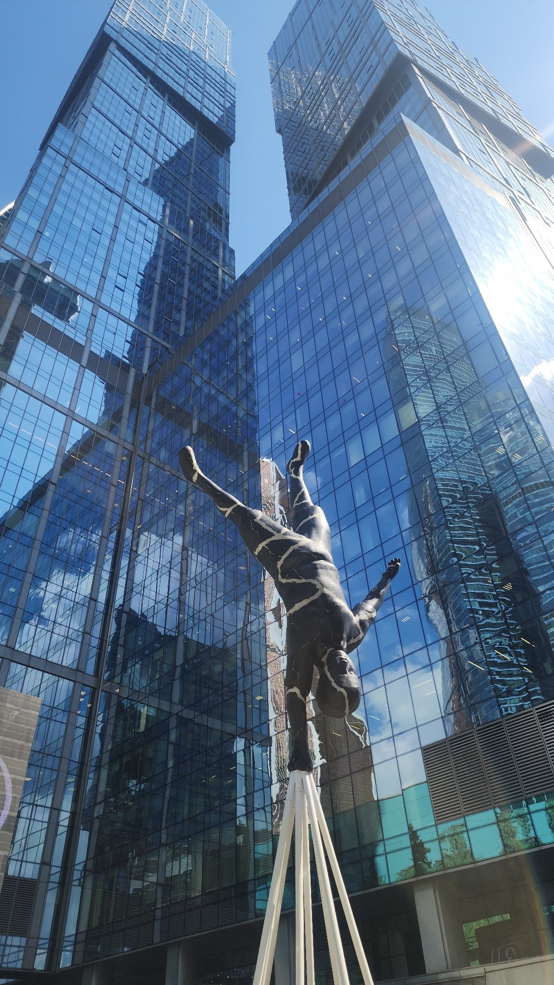 Morning at Moscow City's towers, sculptures, and parked motorcycles