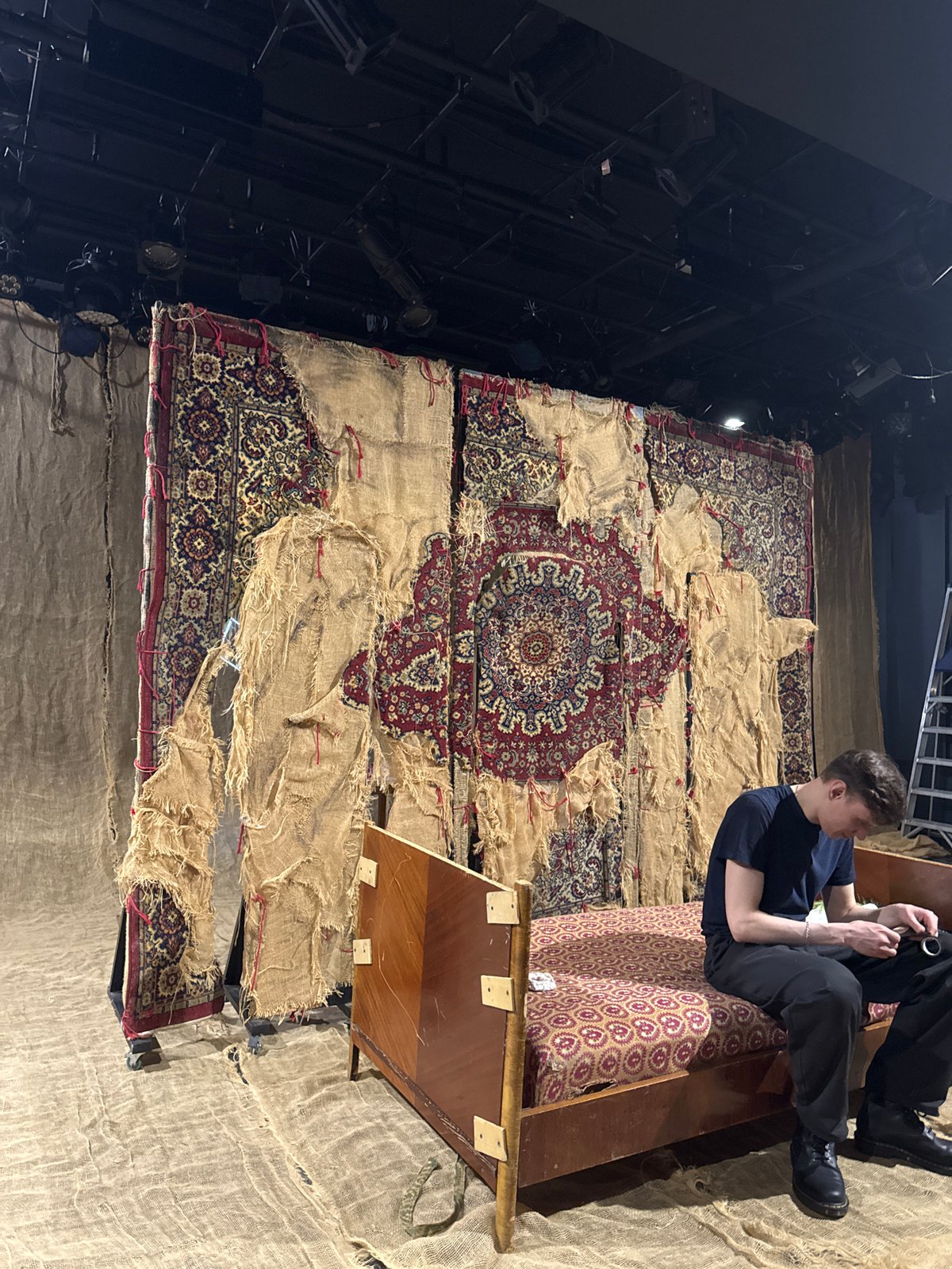 Man examines object while seated on furniture in Moscow