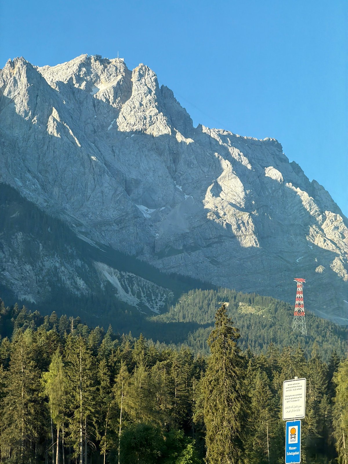 Evergreen forest and Alpine peaks near Grainau on a clear day