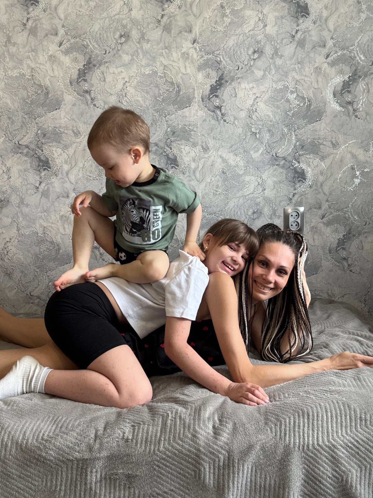Family shares playful moment indoors in Zhukovo, Russia