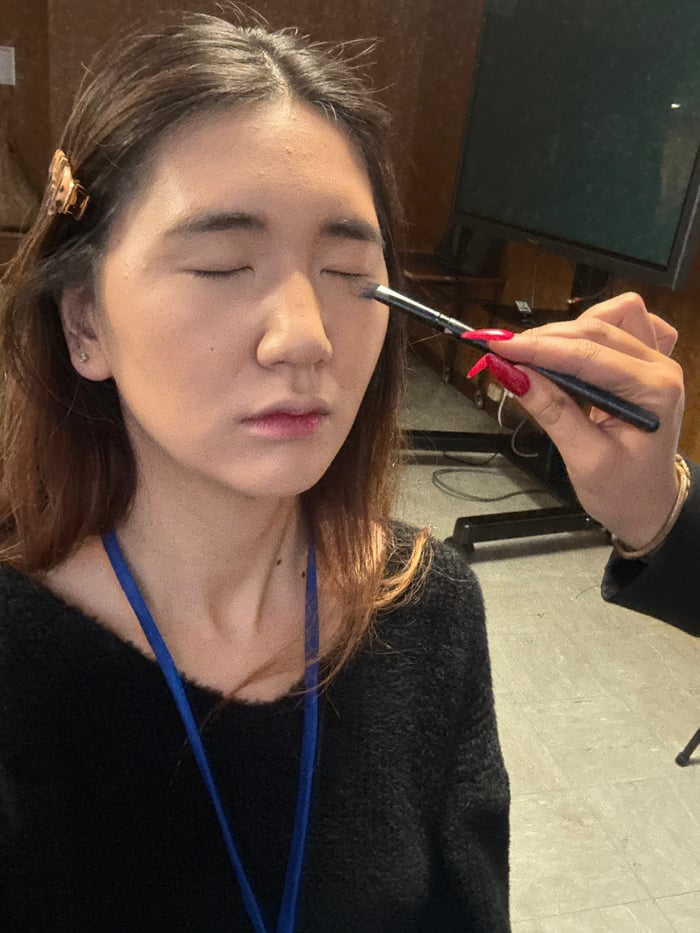 Morning makeup session documented in Paris workplace setting