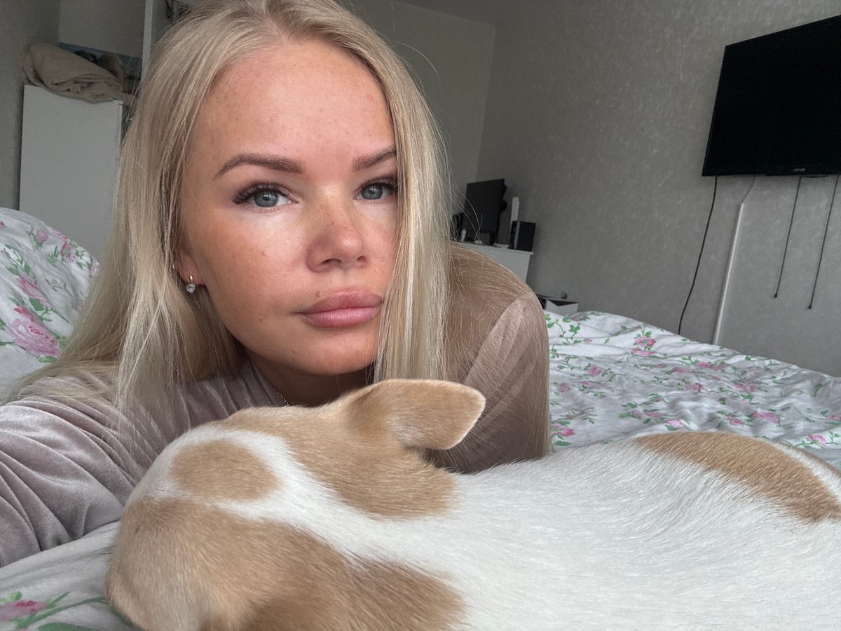 Woman and chihuahua share quiet morning moment in bedroom