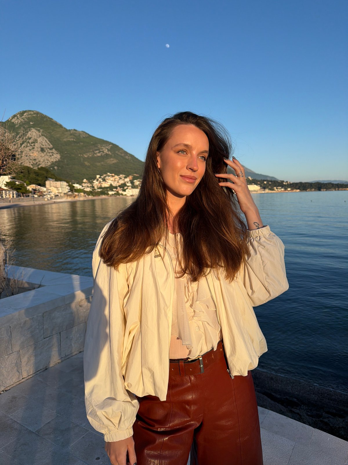 Woman poses for photos during sunset in Montenegro coastal town