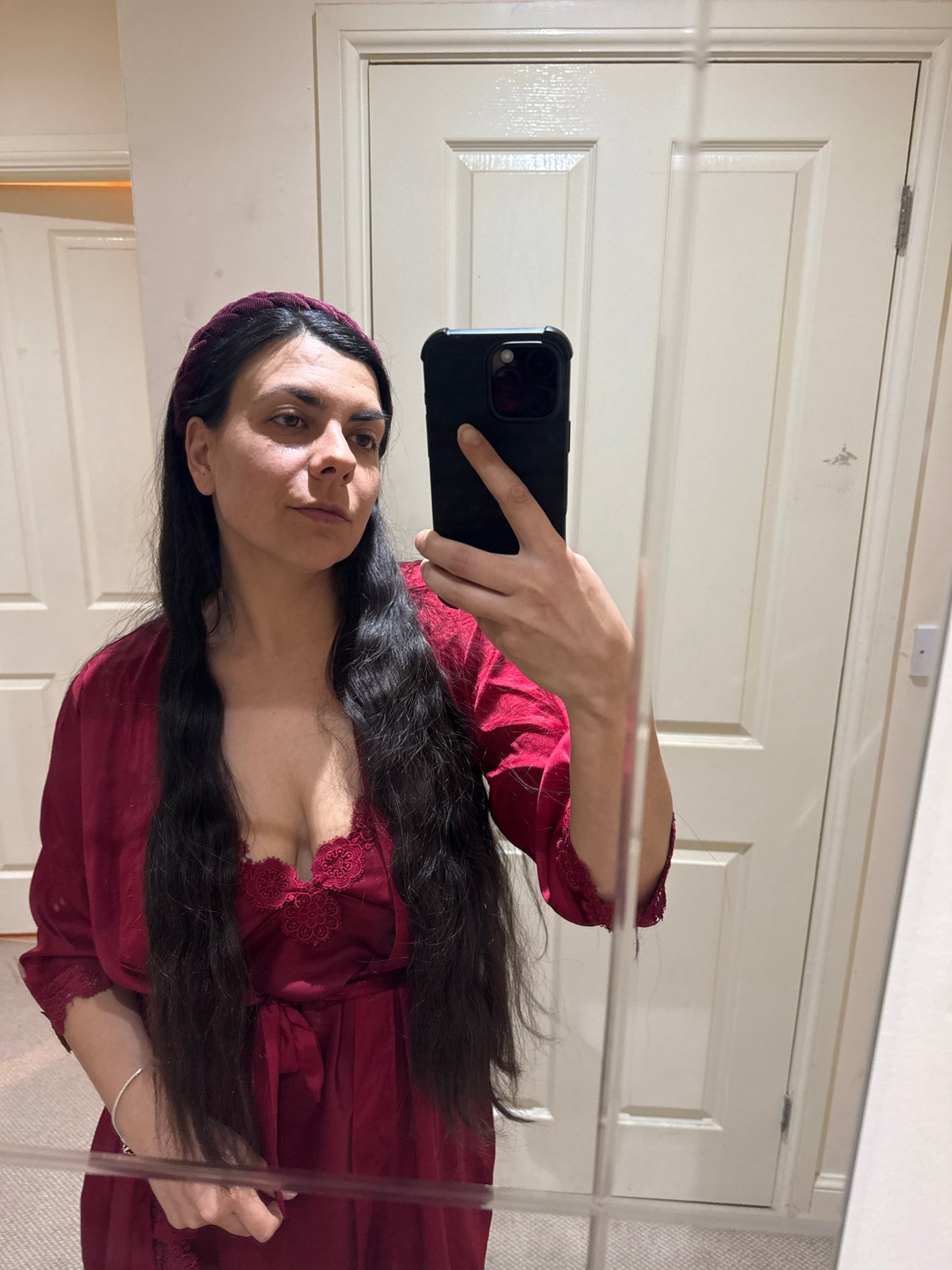 Woman takes mirror selfie in burgundy outfit, Great Yarmouth