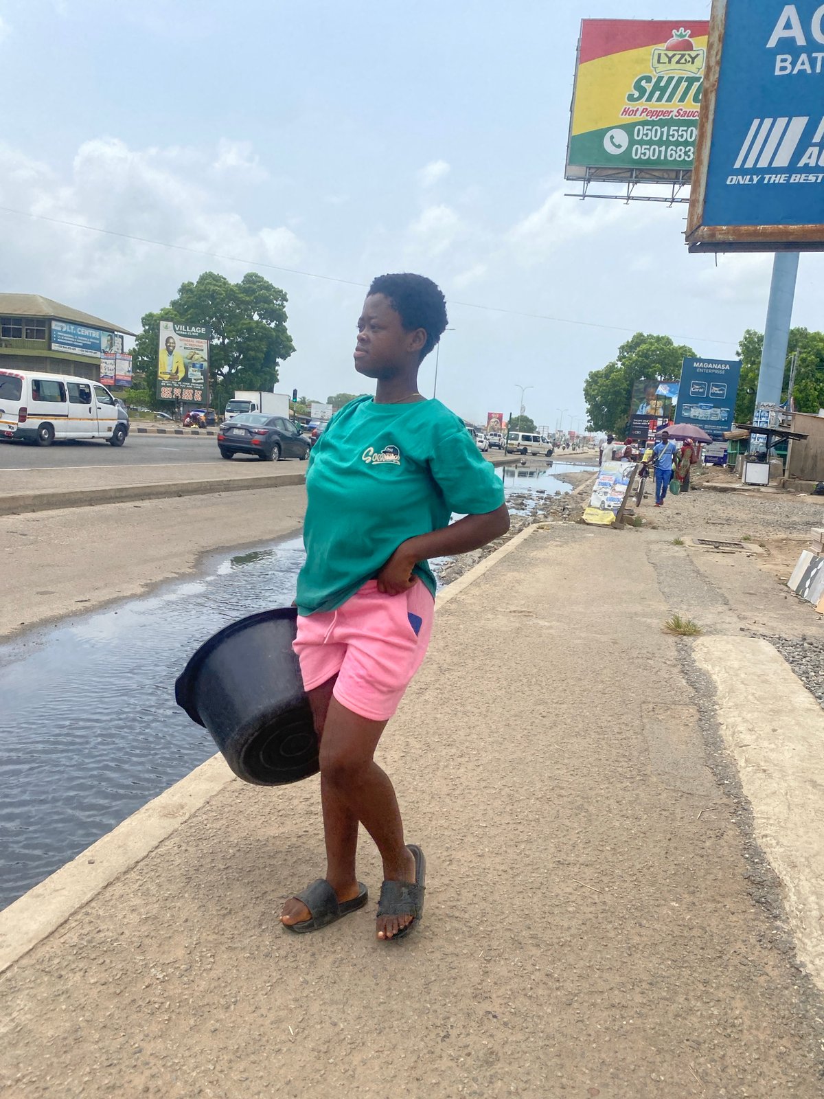 Daily street life unfolds in commercial Accra district