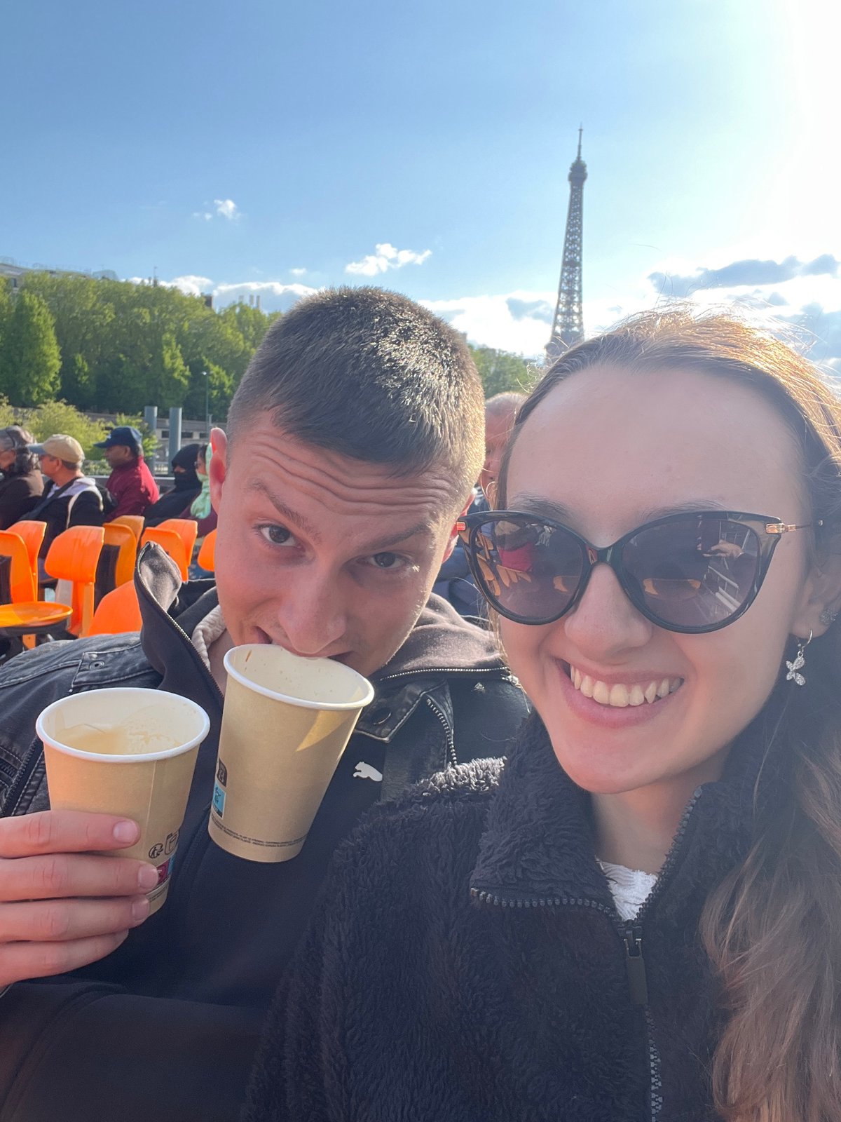 Tourists capture sunny afternoon moments around Eiffel Tower, Seine River