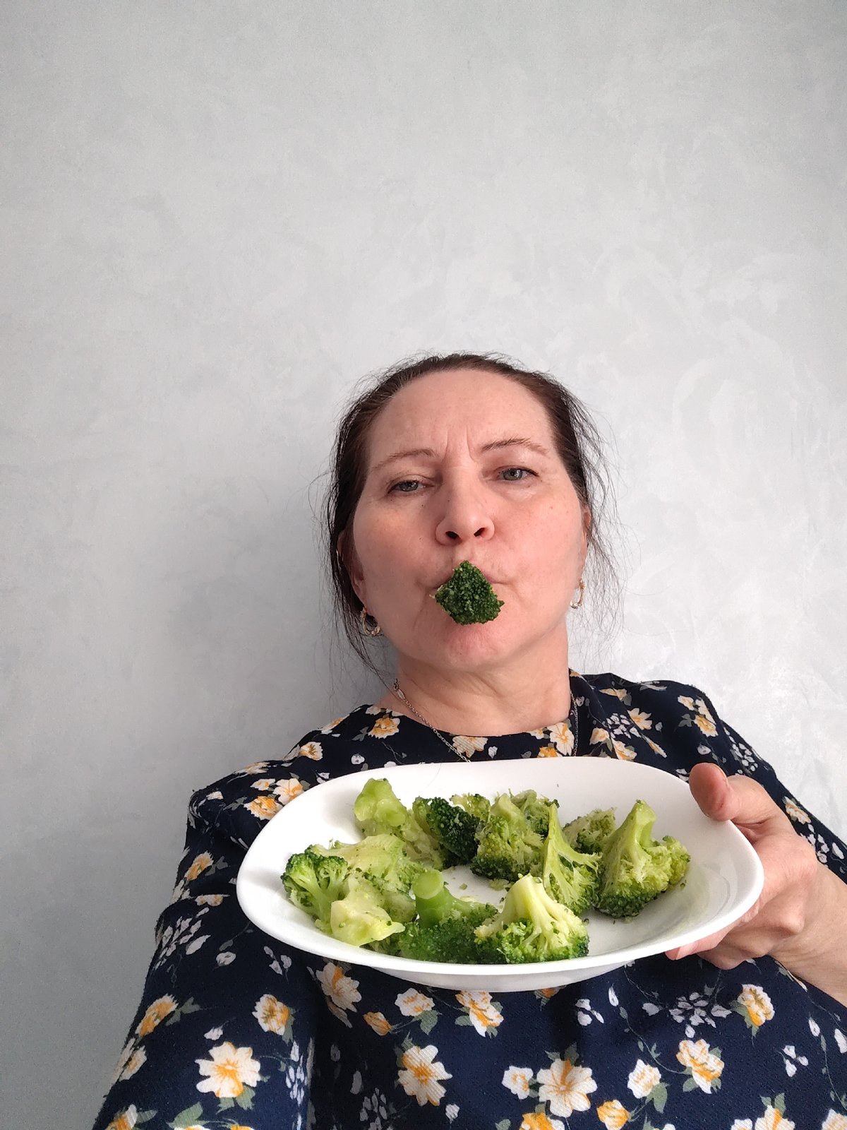 Woman plays with food, poses playfully in Sarapul kitchen