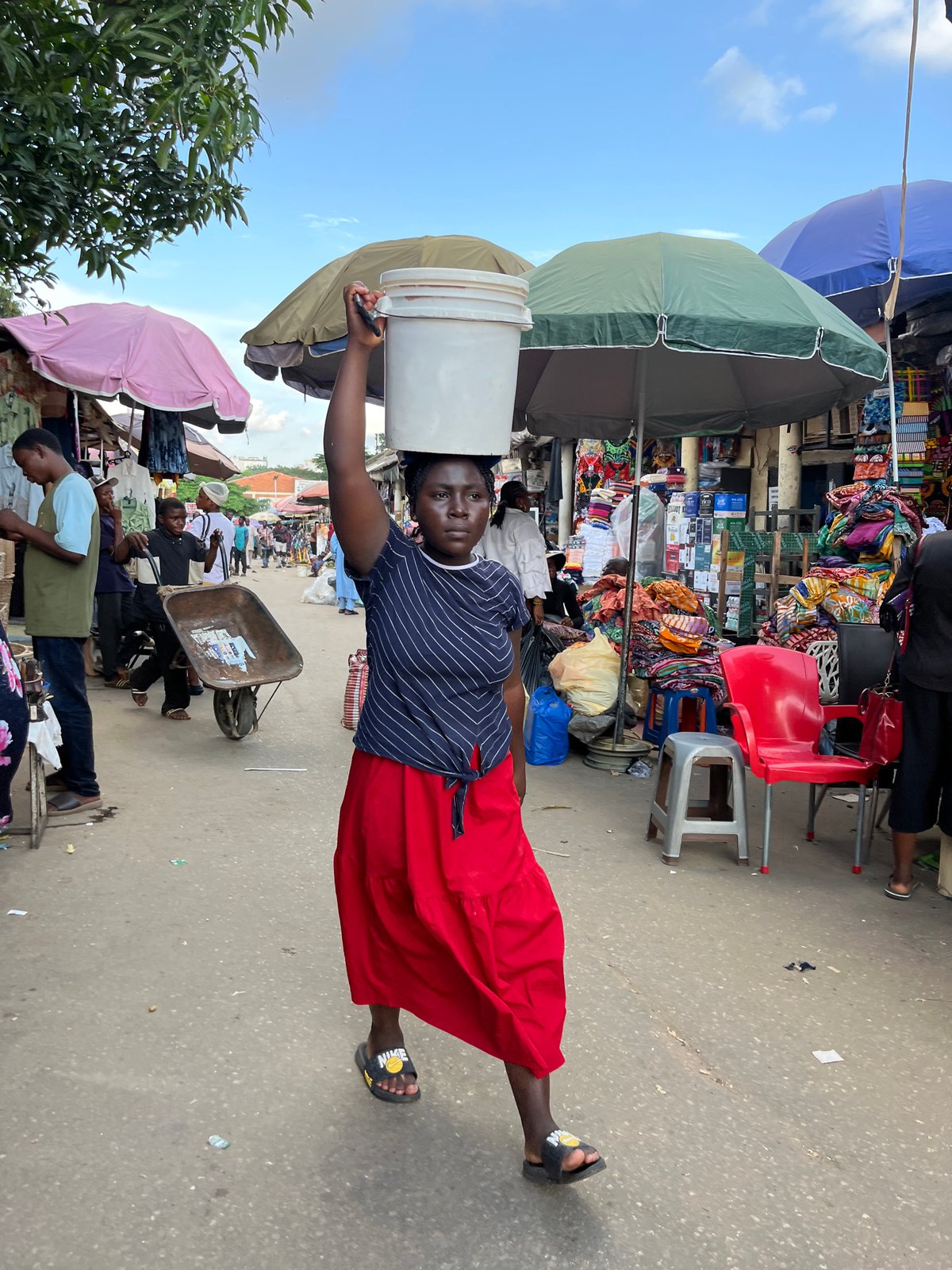 Abuja street market buzzing with vendors and shoppers