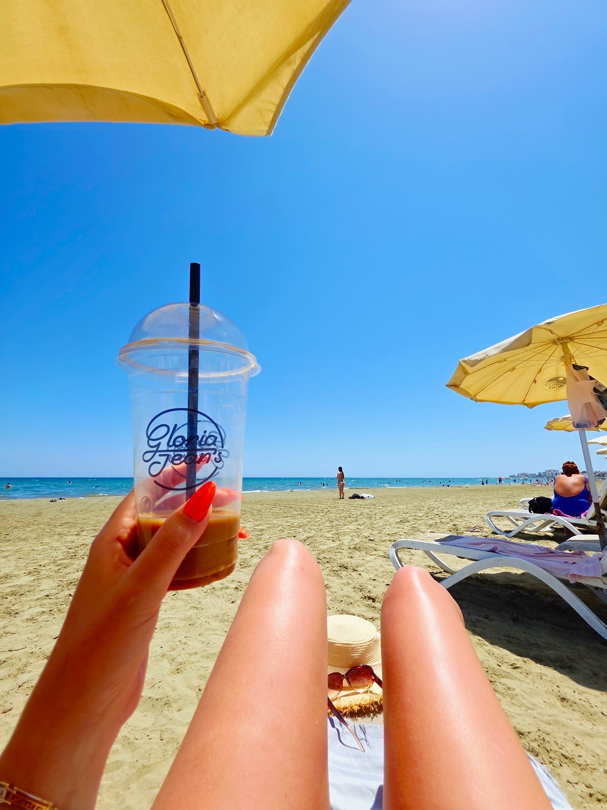 Relaxed beach morning in Larnaca with iced coffee in hand