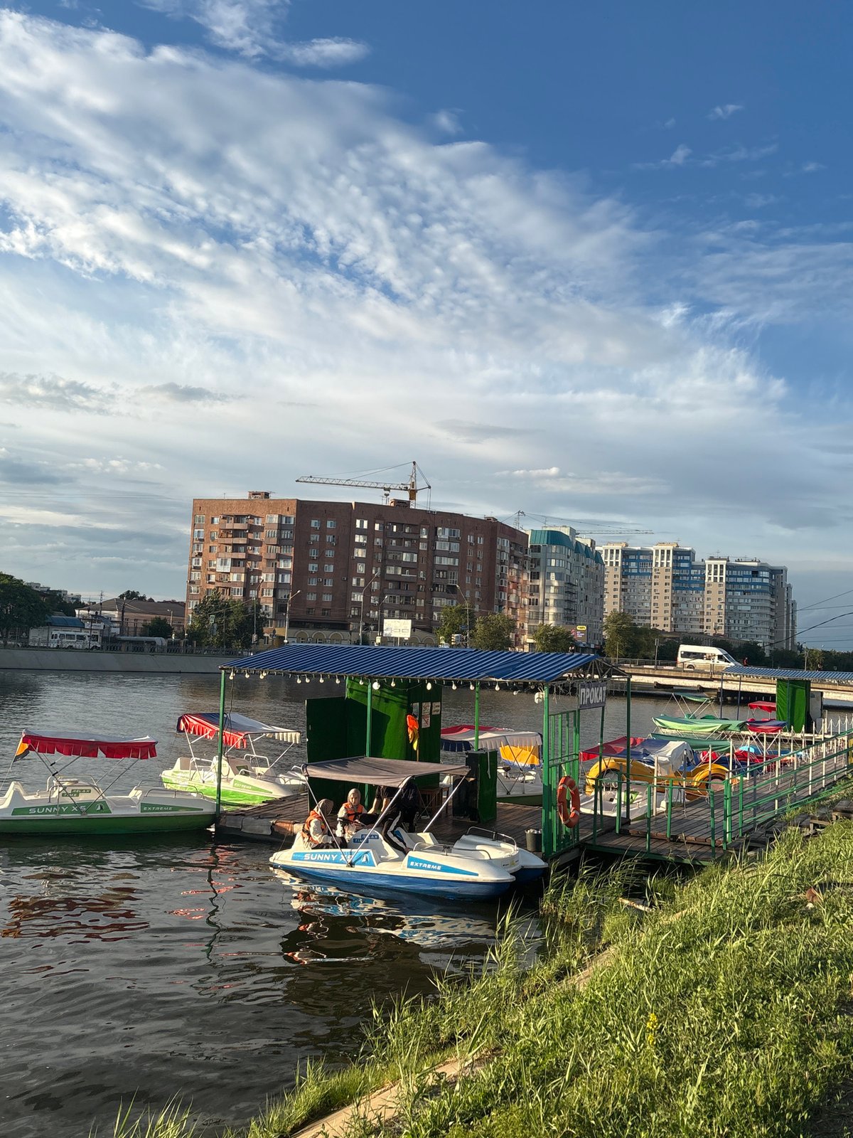 Astrakhan waterfront on a summer afternoon — boats, ponies, church domes