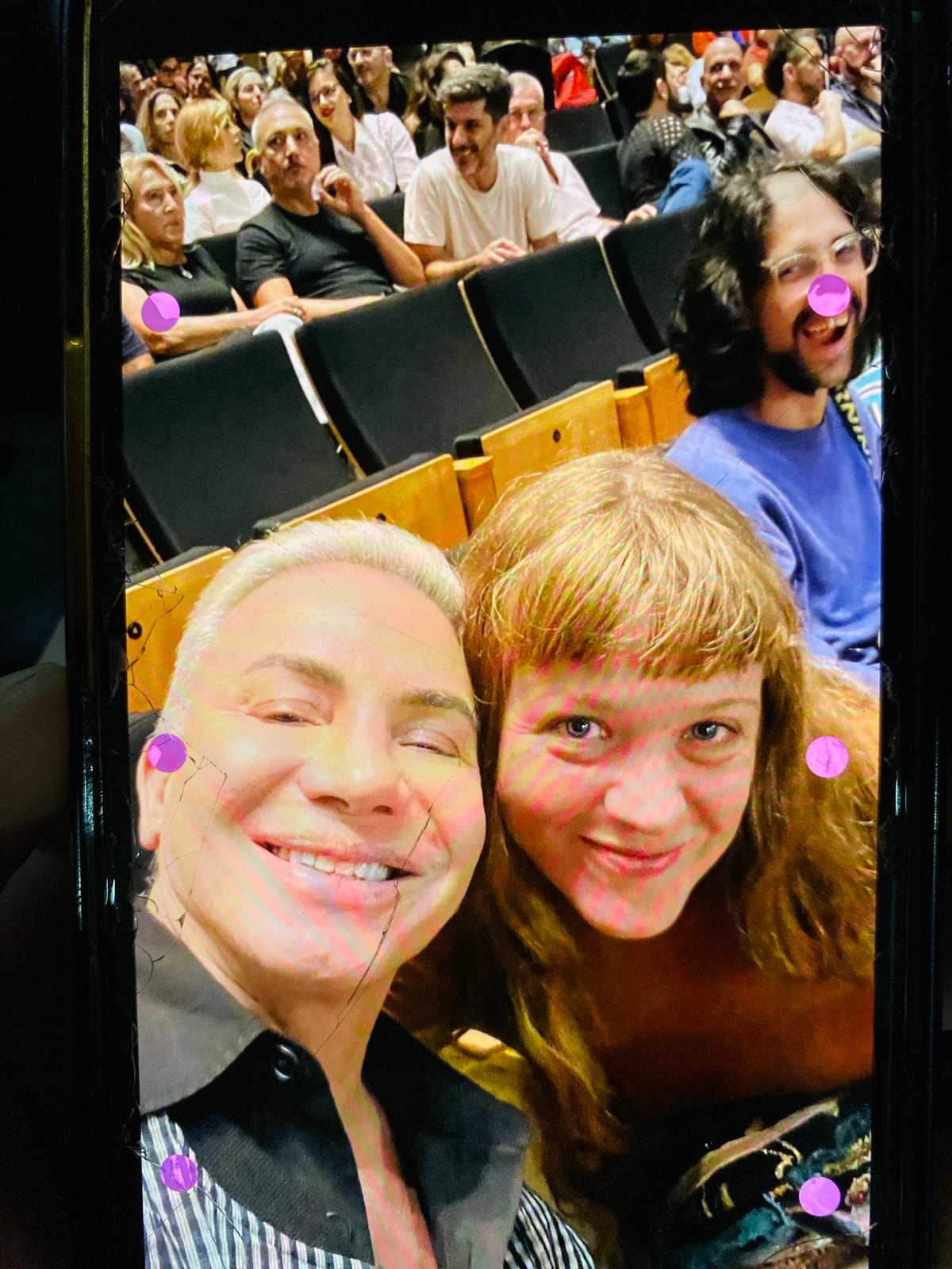 Three people photographed on screen during Buenos Aires auditorium event