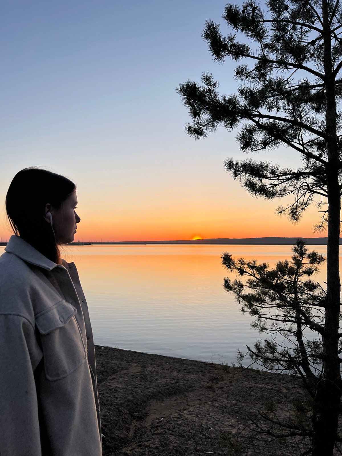 Sunset gathering documented along Chaikovsky waterfront with beverage toast