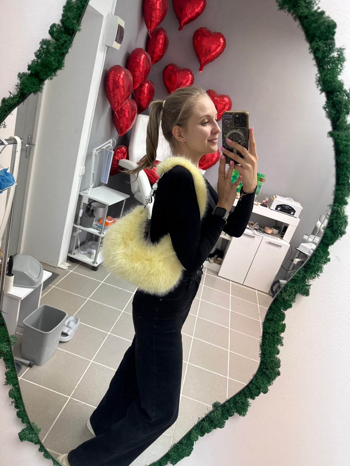 Woman documents selfie session in decorated Izhevsk interior space