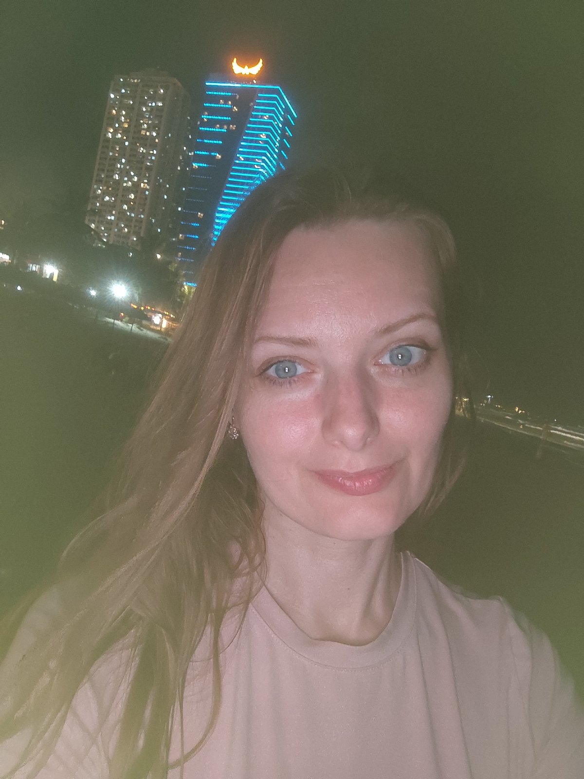 Woman photographed during nighttime beach gathering in Đà Nẵng