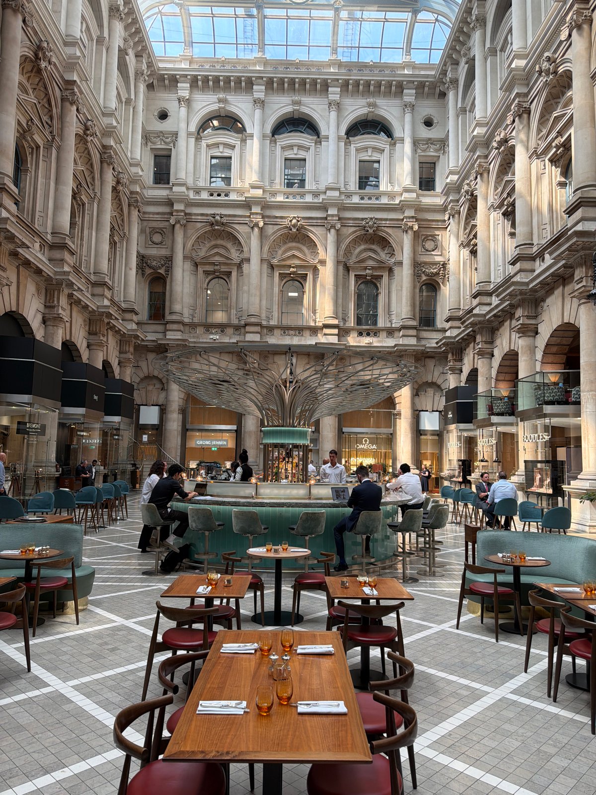 Inside the Royal Exchange's sunlit atrium, City of London