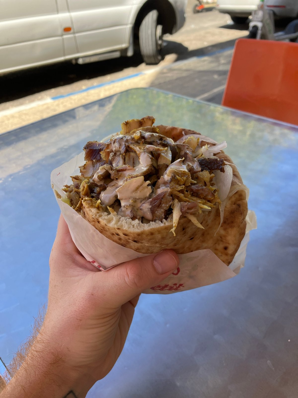 Person holds shawarma wrap in Holon, Israel