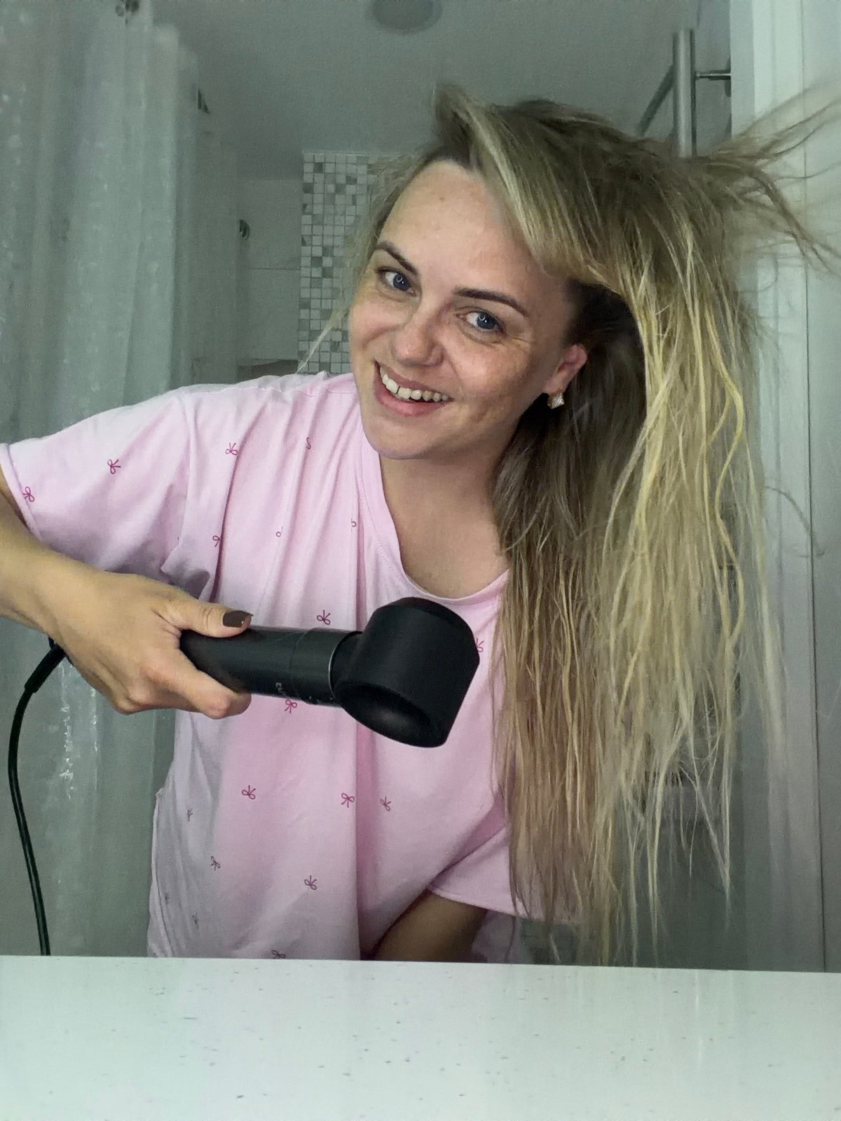 Woman dries hair, takes selfies with dog in Russian bathroom