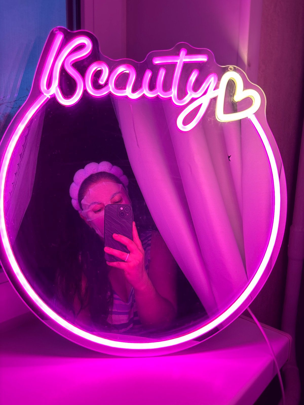Person takes selfie at illuminated beauty mirror in Chaikovsky