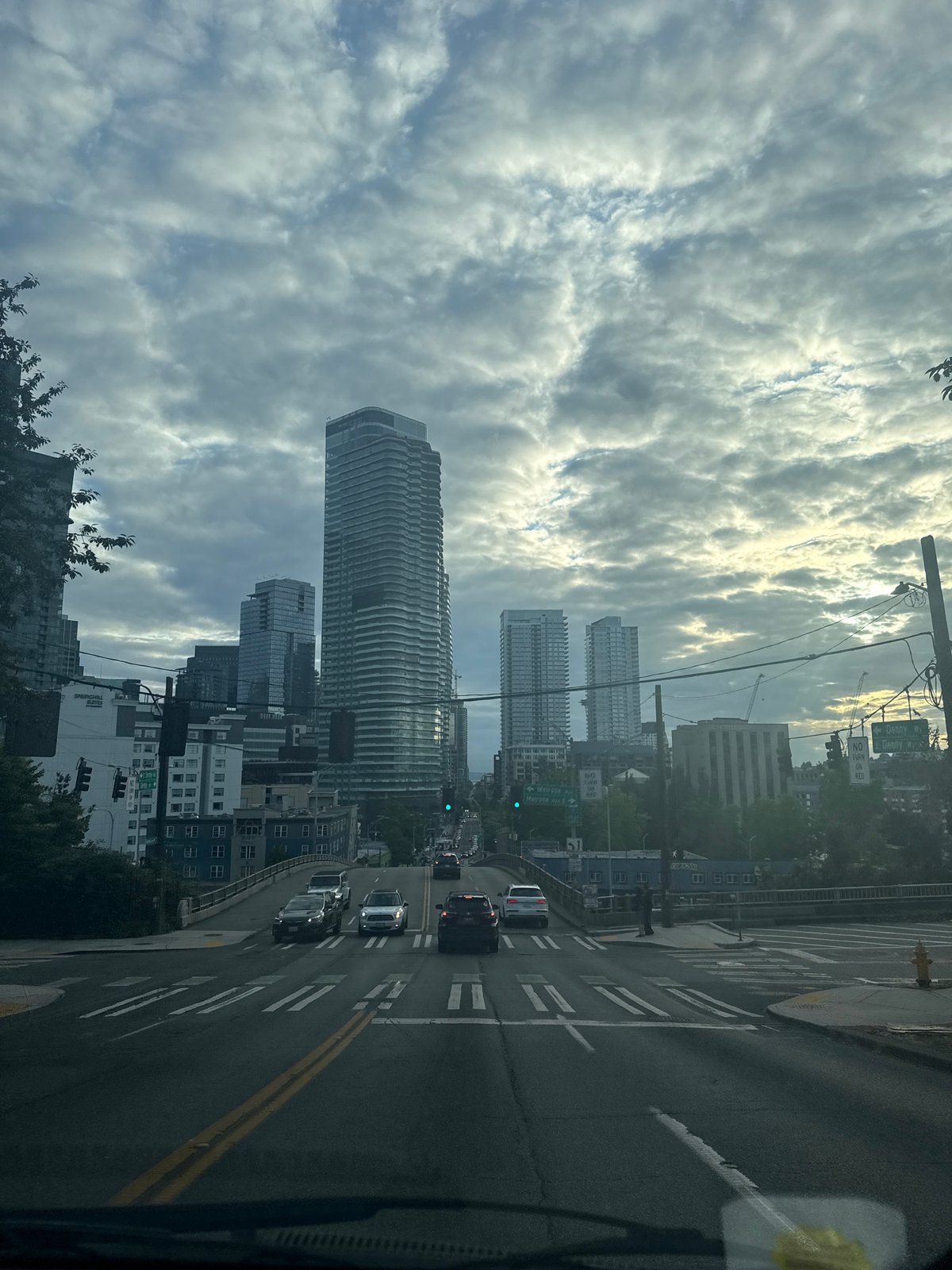 Downtown city streets, skyscrapers, and a painted utility box