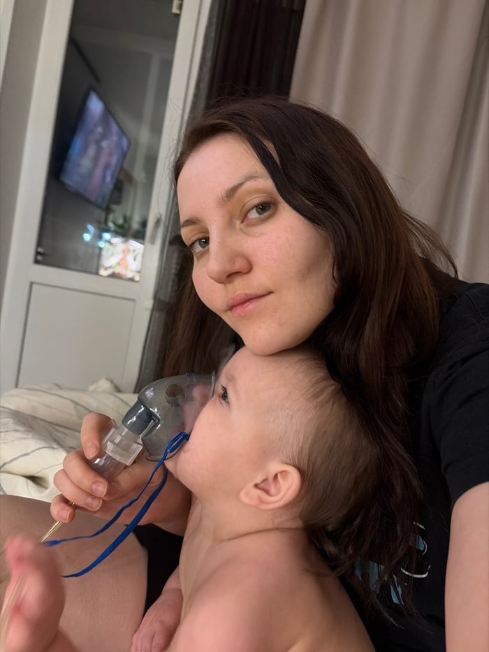 Russian mother tends baby, plays with cat during quiet morning