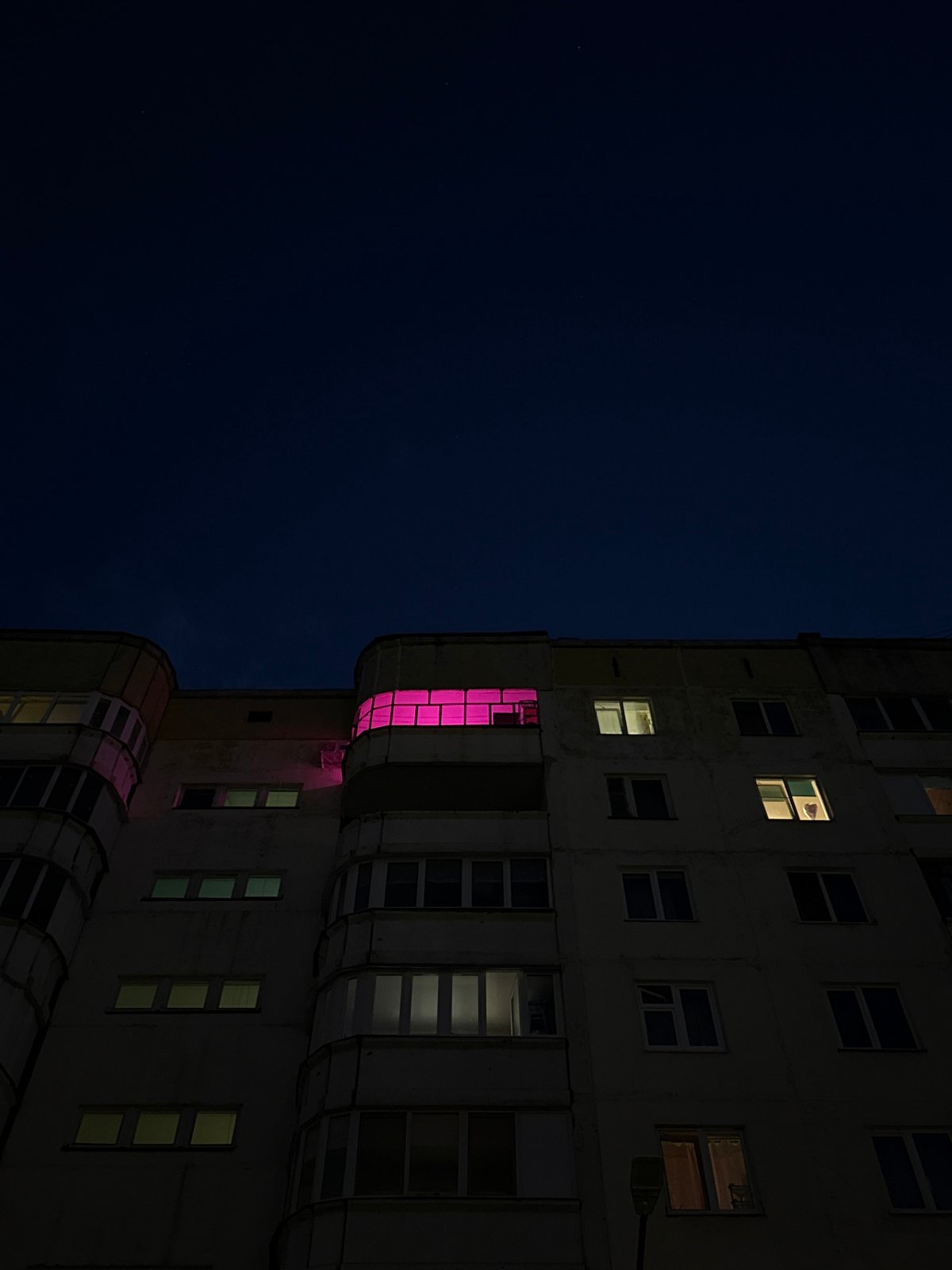 Perm building displays pink-glowing windows at night