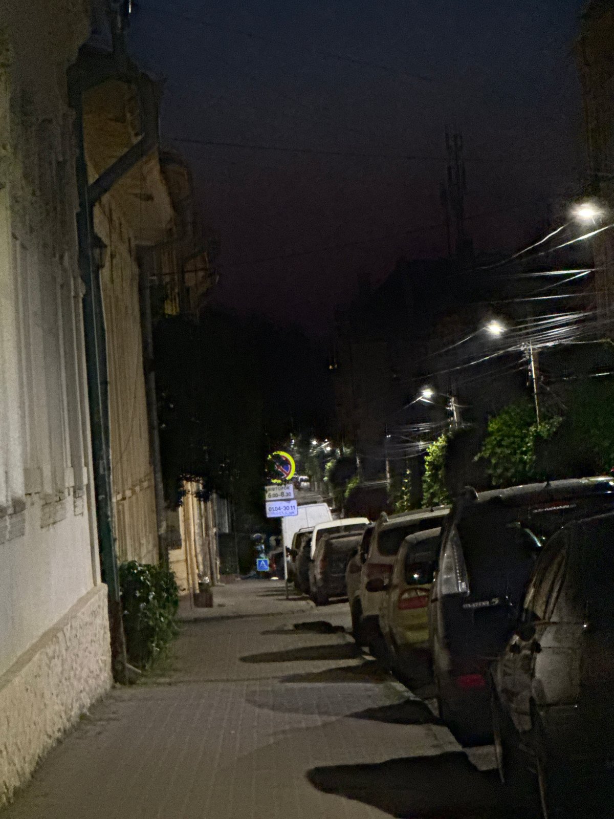 Full moon over parked cars on a quiet Chernivtsi street