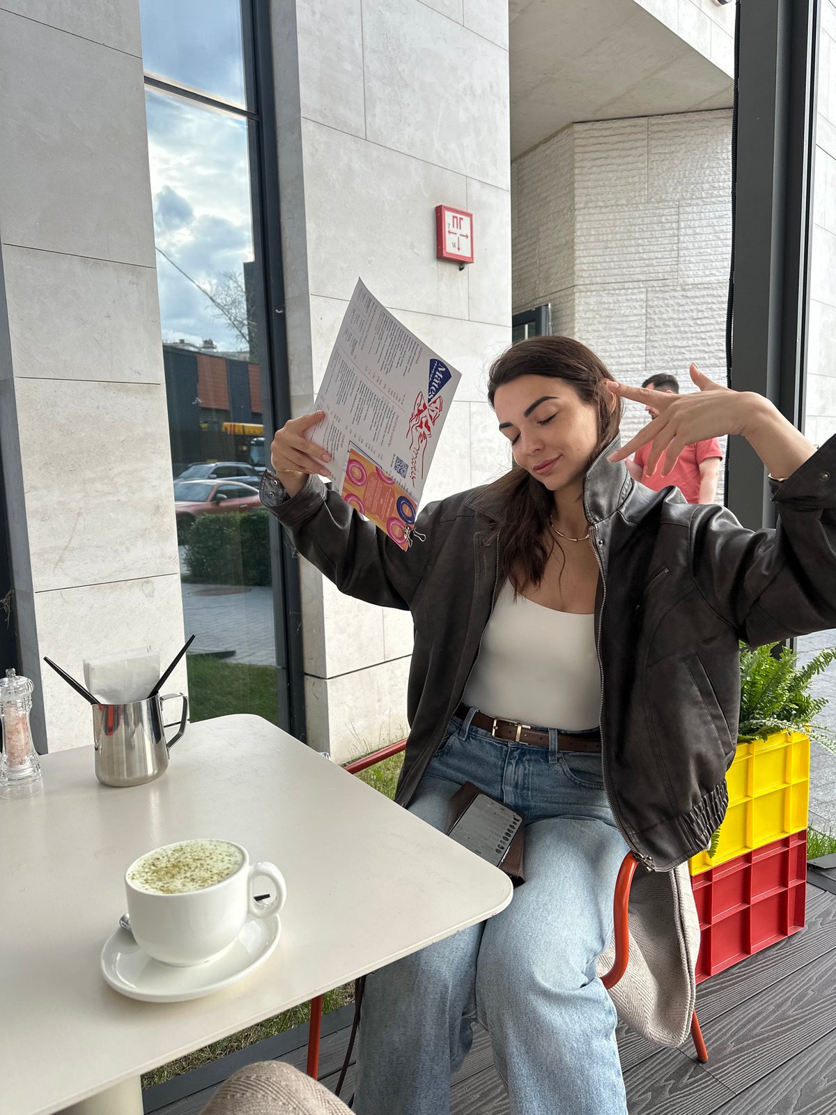 Afternoon café stop in Moscow: menus, nail polish, window reflections.