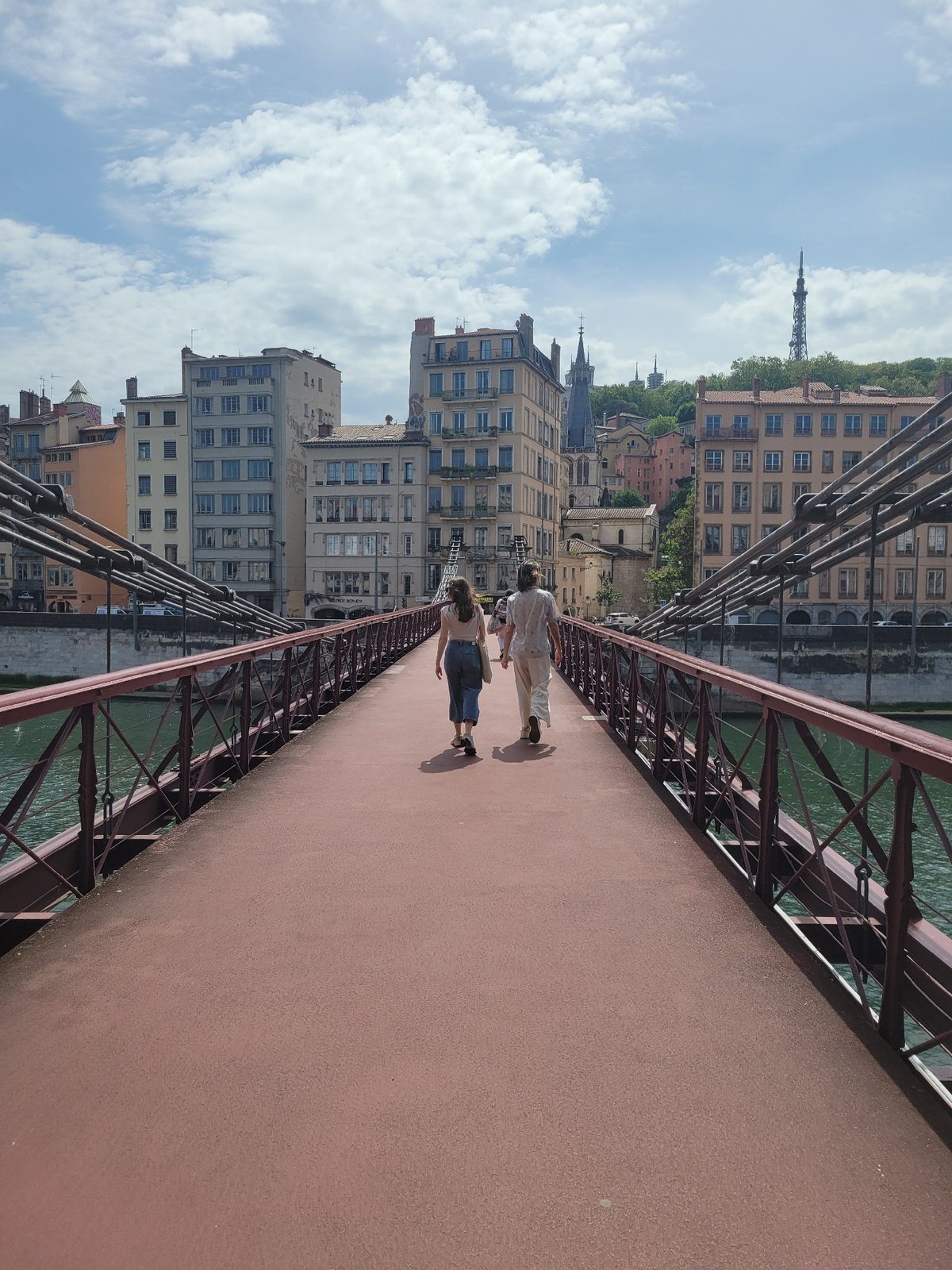 Two women walk pedestrian bridge in Lyon