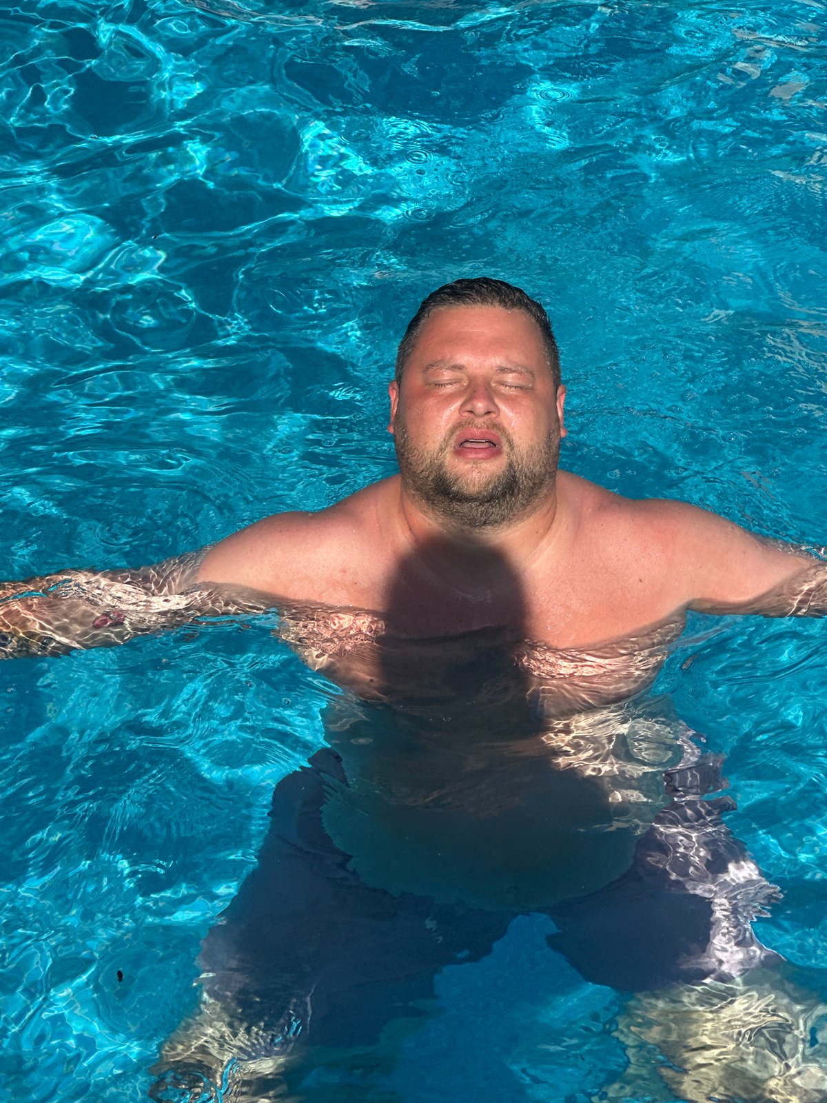 Father and toddler enjoy poolside afternoon in Spanish coastal town
