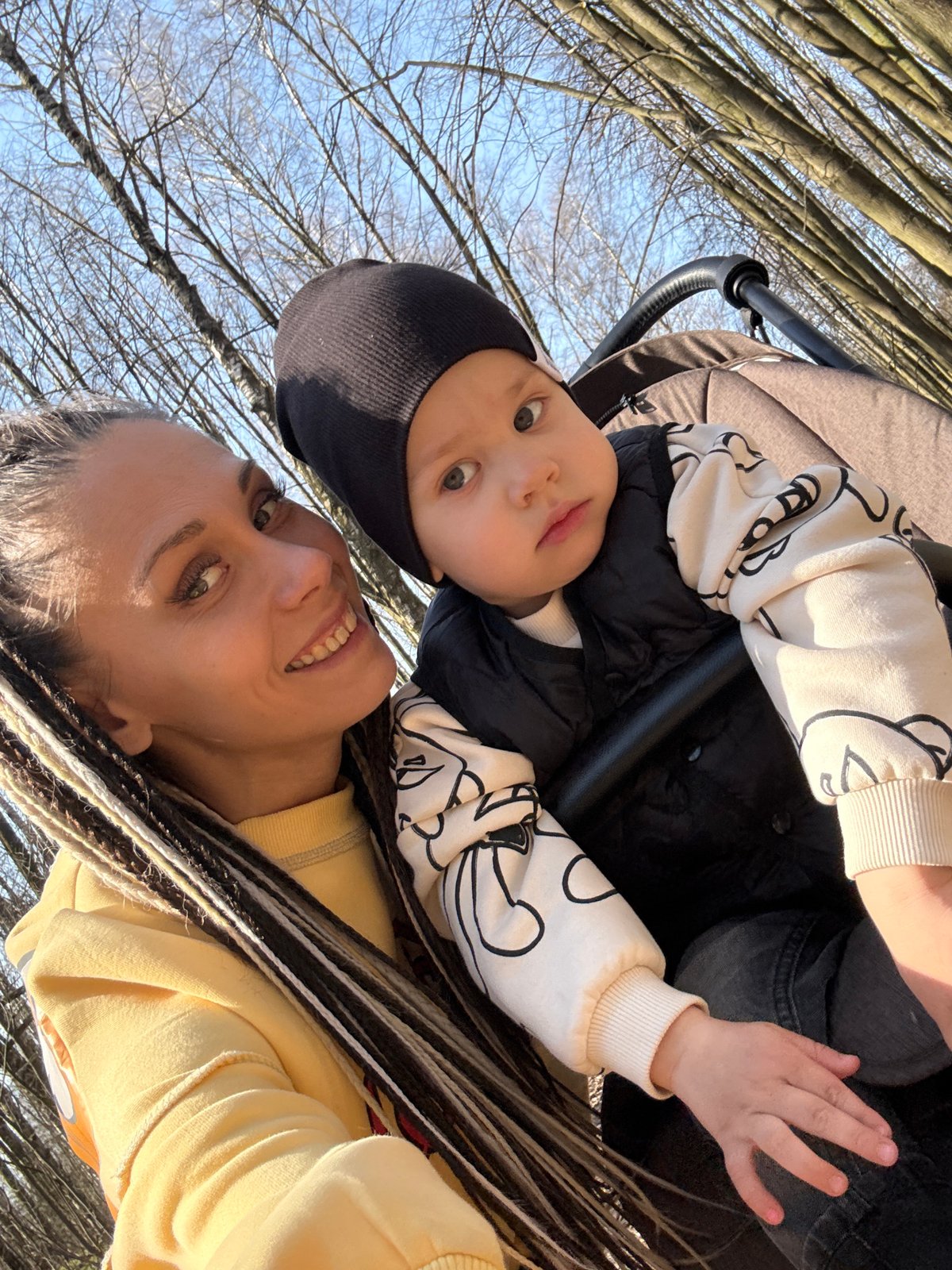 Woman with baby stroller photographed in wooded area near Bor