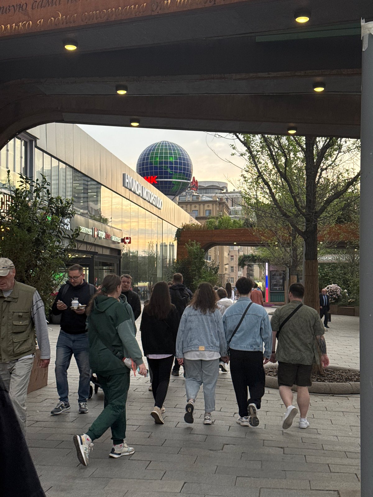 Pedestrians walk through Moscow public area, retail display observed