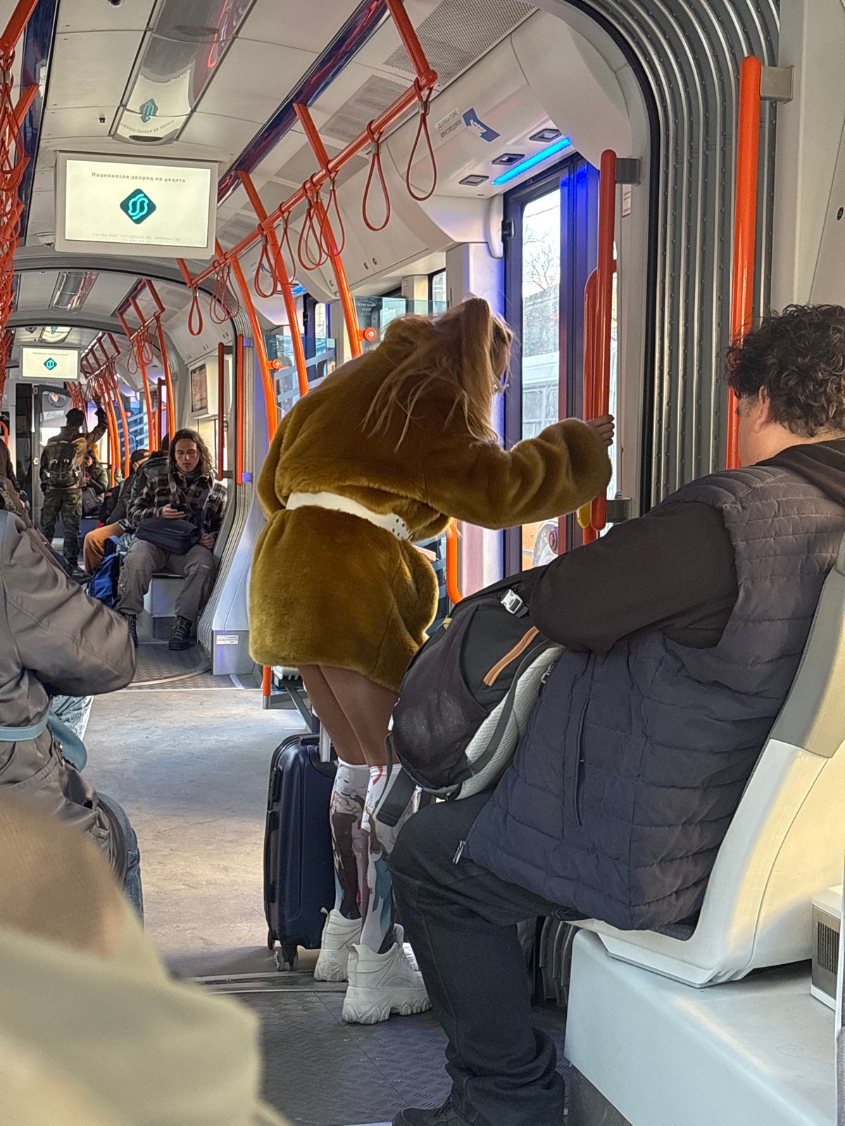 Man in dark vest rides Sofia subway during afternoon commute